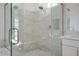 Modern bathroom featuring marble tile shower with glass door and built-in seat at 2265 Lauren Dr, Las Vegas, NV 89134