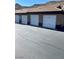 View of garages featuring white doors, tile roofing, and ample parking space at 231 W Horizon Ridge Pkwy # 514, Henderson, NV 89012