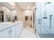 Bright bathroom with dual sinks, a walk-in shower, and a neutral color scheme, exuding a clean aesthetic at 2392 Mystic Star St, Henderson, NV 89044