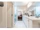 Modern bathroom with dual sinks, white cabinets, and a glass-enclosed shower, providing a spa-like retreat at 2392 Mystic Star St, Henderson, NV 89044