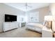 Cozy bedroom with white furnishings and a well-lit vanity area, creating a serene ambiance at 2392 Mystic Star St, Henderson, NV 89044