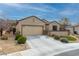 Charming single-story home with a well-maintained lawn and desert landscaping at 2392 Mystic Star St, Henderson, NV 89044