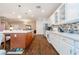 Bright kitchen with island, white cabinetry, stainless steel appliances, and modern backsplash at 2392 Mystic Star St, Henderson, NV 89044