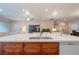 Spacious kitchen island with sink, modern faucet, and stainless steel appliances at 2392 Mystic Star St, Henderson, NV 89044