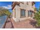 Backyard shows a corner of the home with rock landscaping and stone pavers at 2478 Cordoba Bluff Ct, Las Vegas, NV 89135