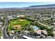 Overhead view of a neighborhood park with baseball fields, community pool and clubhouse amid tree-lined streets at 2597 Belgreen St, Las Vegas, NV 89135