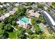 Aerial shot of the community clubhouse featuring a sparkling pool, playground, basketball court and ample green space at 2597 Belgreen St, Las Vegas, NV 89135