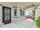 Inviting front porch features a decorative iron door and well-maintained concrete at 2597 Belgreen St, Las Vegas, NV 89135