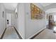 Hallway decorated with a gallery wall, leading to various rooms, and patterned runners at 2597 Belgreen St, Las Vegas, NV 89135