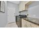 Convenient laundry room featuring modern washer and dryer, storage cabinets, and tile floor at 2597 Belgreen St, Las Vegas, NV 89135