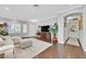 Spacious living room featuring hardwood floors, neutral paint, large windows, and an open floor plan at 2597 Belgreen St, Las Vegas, NV 89135