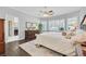 Comfortable main bedroom with plantation shutters, wood flooring, a ceiling fan, and soft lighting at 2597 Belgreen St, Las Vegas, NV 89135