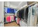 Well-organized walk-in closet with ample hanging space, shelving, and storage benches at 2597 Belgreen St, Las Vegas, NV 89135