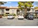 Well-maintained building exterior with covered parking, mature trees, and convenient parking spaces at 2606 S Durango Dr # 276, Las Vegas, NV 89117