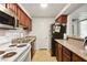 Functional kitchen featuring tile floors and countertops, ample cabinet space, and essential appliances at 2606 S Durango Dr # 276, Las Vegas, NV 89117