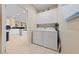 Bright laundry room features a side-by-side washer and dryer set and ample white cabinet storage above at 2921 Hayden Creek Ter, Henderson, NV 89052