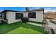 Backyard featuring artificial turf, modern white exterior, and black trim at 321 Agora Way, Las Vegas, NV 89110