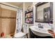 Tiled bathroom with dark accents featuring a full shower and decorative shelving for storage at 321 Agora Way, Las Vegas, NV 89110