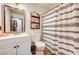 Cozy bathroom featuring a toilet and a shower curtain with a patterned design at 321 Agora Way, Las Vegas, NV 89110