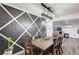 Stylish dining room featuring a rustic wooden table and chairs, modern light fixture, and a decorative accent wall at 321 Agora Way, Las Vegas, NV 89110