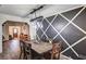 Stylish dining room featuring a rustic wooden table and chairs, modern light fixture, and an eye-catching accent wall at 321 Agora Way, Las Vegas, NV 89110