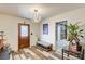 Inviting entryway boasting stylish flooring, elegant light fixture, and a beautiful wood front door at 321 Agora Way, Las Vegas, NV 89110