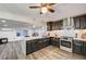 A spacious kitchen featuring dark cabinetry, granite countertops, and stainless steel appliances at 321 Agora Way, Las Vegas, NV 89110