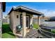 View of the home's outdoor bonus room featuring artifical lawn, a small porch, and a walkway at 321 Agora Way, Las Vegas, NV 89110