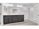 Bright bathroom featuring a double sink vanity with a shower behind sliding glass doors at 382 Gracious Way, Henderson, NV 89011