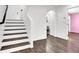 Welcoming entryway with hardwood floors, staircase, and neutral color palette at 382 Gracious Way, Henderson, NV 89011