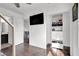 Hallway with hardwood floors, closet, and view into the bathroom at 382 Gracious Way, Henderson, NV 89011