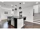 Kitchen island with granite countertop, modern pendant lighting, and seating at 382 Gracious Way, Henderson, NV 89011