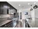 Modern kitchen featuring stainless steel appliances, dark wood cabinets, and granite countertops at 382 Gracious Way, Henderson, NV 89011