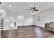 Spacious living room featuring hardwood floors, a ceiling fan, and a staircase at 382 Gracious Way, Henderson, NV 89011