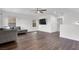 Open concept living room featuring hardwood floors, television, and lots of natural light at 382 Gracious Way, Henderson, NV 89011