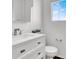 Powder room featuring a white vanity and marble countertop and a window providing natural light at 382 Gracious Way, Henderson, NV 89011