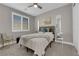 Cozy bedroom featuring plush carpet, a ceiling fan, bright windows and neutral decor, creating a serene space at 41 Via Verso Lago, Henderson, NV 89011