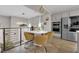 Upper-level dining area with modern furniture, stainless steel appliances, and railing overlooking the living area at 41 Via Verso Lago, Henderson, NV 89011