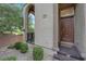 Welcoming front entrance with decorative shrubs and a walkway leading to a private courtyard at 41 Via Verso Lago, Henderson, NV 89011