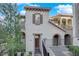 Charming home features a private entry with wrought iron details and landscaped walkway at 41 Via Verso Lago, Henderson, NV 89011