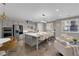 Bright kitchen and living area with stainless steel appliances, island seating, and modern furnishings at 41 Via Verso Lago, Henderson, NV 89011