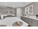 Bright kitchen with gray cabinets, white countertops, stainless steel appliances, and natural light streaming in at 41 Via Verso Lago, Henderson, NV 89011