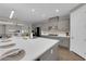 Bright kitchen featuring an oversized island, stainless steel appliances, and elegant gray cabinetry for a modern touch at 41 Via Verso Lago, Henderson, NV 89011