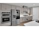 Contemporary kitchen featuring stainless steel appliances, gray cabinetry, and a stylish backsplash for a sleek, modern feel at 41 Via Verso Lago, Henderson, NV 89011