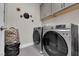 Well-equipped laundry room with modern washer and dryer, plus storage cabinets at 41 Via Verso Lago, Henderson, NV 89011