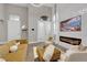 Bright living room featuring a sleek fireplace, stylish seating, and soaring ceilings at 41 Via Verso Lago, Henderson, NV 89011