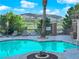 Community pool boasts a sparkling pool, a mountain view, seating, and well maintained landscaping at 41 Via Verso Lago, Henderson, NV 89011