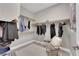 Organized walk-in closet with ample hanging space and chair at 41 Via Verso Lago, Henderson, NV 89011