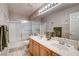 Double sink bathroom vanity with modern fixtures and large mirror over tile floors at 420 Blush Creek Pl, Las Vegas, NV 89144