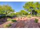 Park featuring a stone picnic table surrounded by lush greenery and a peaceful atmosphere at 420 Blush Creek Pl, Las Vegas, NV 89144